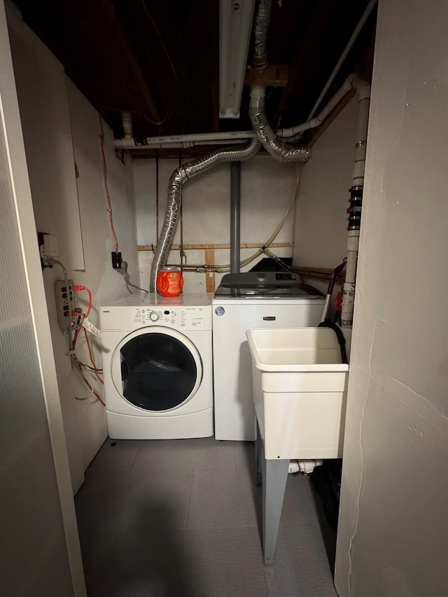 washroom featuring washing machine and dryer and sink