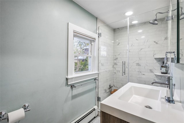 bathroom with an enclosed shower, a baseboard heating unit, and vanity