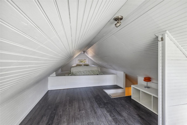 additional living space with lofted ceiling and dark hardwood / wood-style flooring