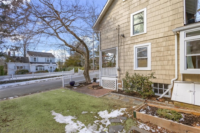 view of side of home with a yard