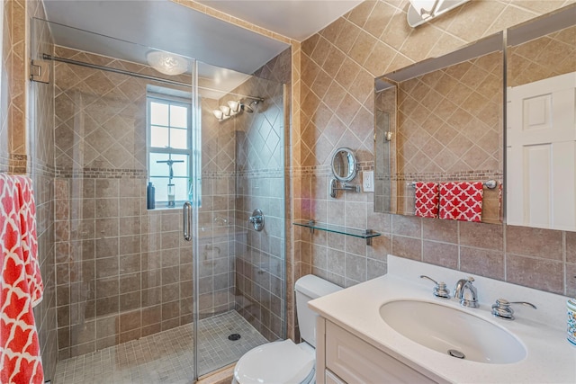 bathroom featuring tile walls, decorative backsplash, vanity, an enclosed shower, and toilet