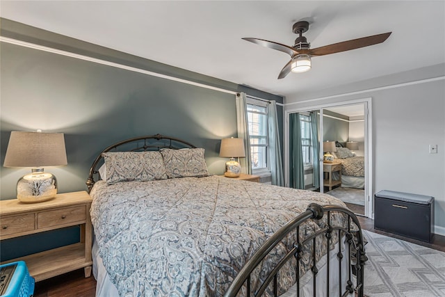 bedroom with hardwood / wood-style floors, a closet, and ceiling fan