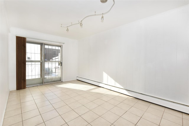 unfurnished room with a baseboard radiator and light tile patterned floors