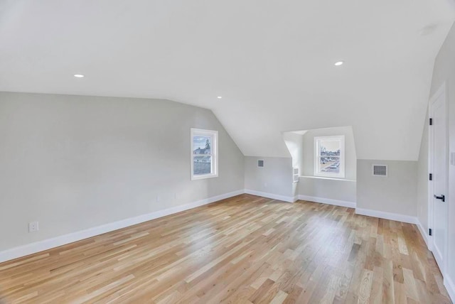 additional living space with lofted ceiling and light wood-type flooring