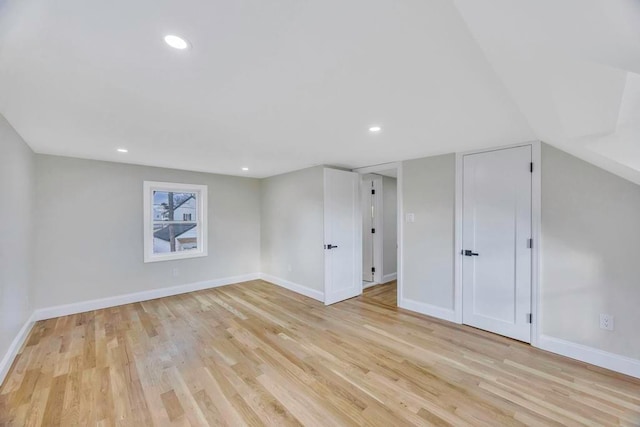 basement with light hardwood / wood-style flooring