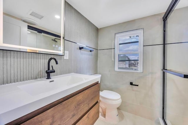 bathroom with walk in shower, vanity, toilet, and tile walls