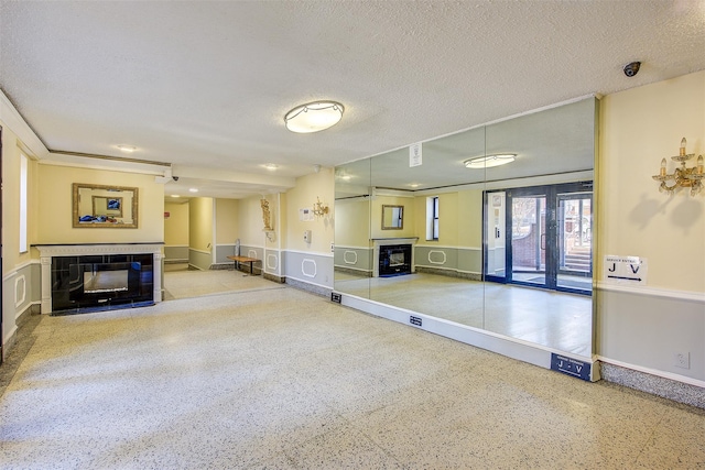 interior space featuring a tiled fireplace and a textured ceiling