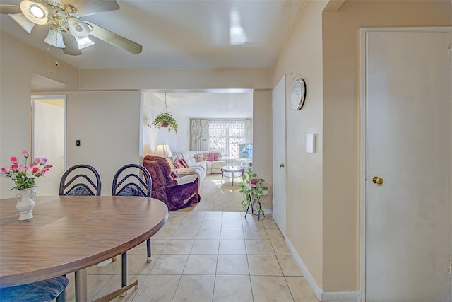 dining space with ceiling fan and light tile patterned floors