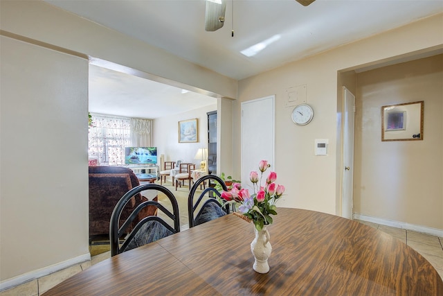 dining space featuring ceiling fan and light tile patterned flooring