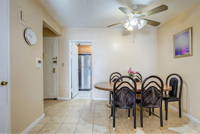 dining space with ceiling fan and light tile patterned floors