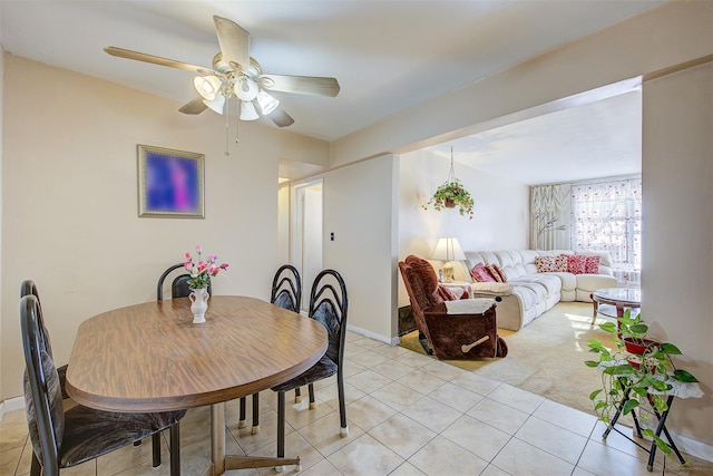 dining space with ceiling fan and light tile patterned floors