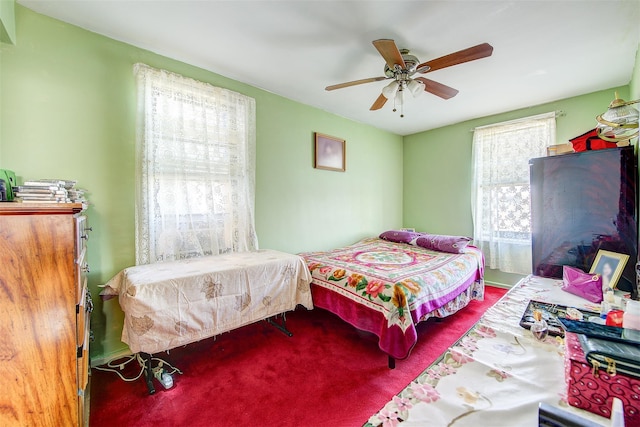 bedroom featuring ceiling fan and carpet