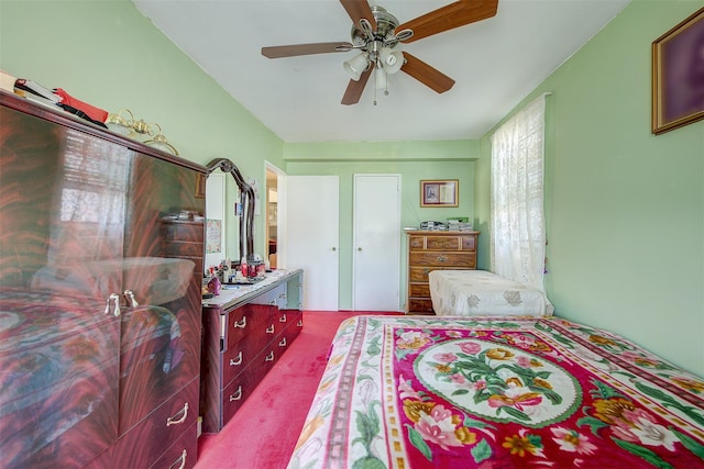 bedroom featuring ceiling fan and carpet