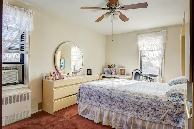 carpeted bedroom with radiator heating unit, ceiling fan, and cooling unit