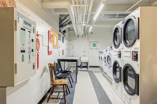 clothes washing area with stacked washer and dryer and separate washer and dryer