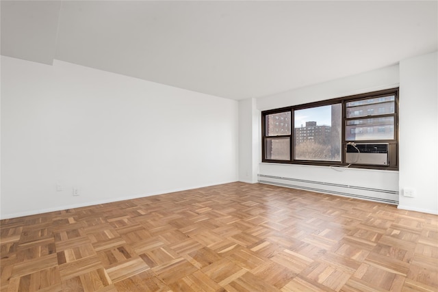 unfurnished room featuring light parquet flooring, a baseboard heating unit, and cooling unit