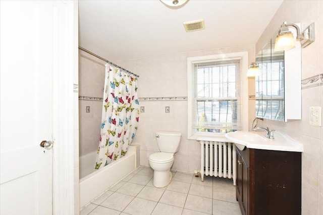 full bathroom featuring tile walls, vanity, shower / bathtub combination with curtain, radiator, and tile patterned flooring