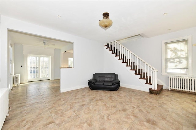 interior space featuring radiator heating unit and ceiling fan