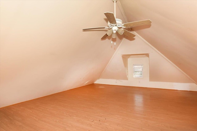 additional living space with hardwood / wood-style flooring and vaulted ceiling