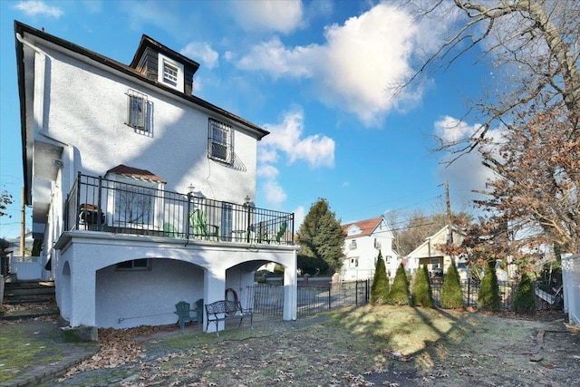 back of house featuring a balcony