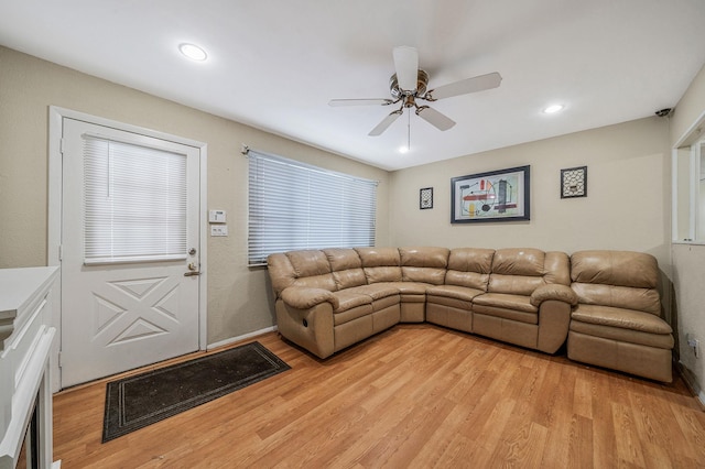 living room featuring ceiling fan and light hardwood / wood-style floors