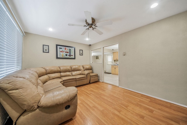 living room with ceiling fan and light hardwood / wood-style floors