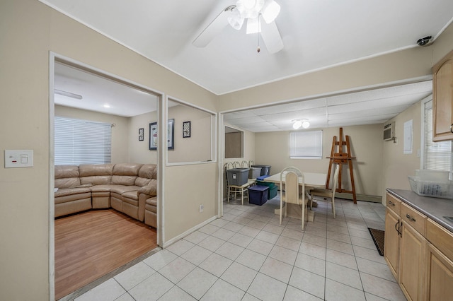 interior space with a wall mounted air conditioner and ceiling fan