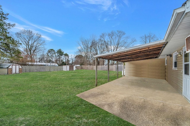 view of yard featuring a storage shed and a patio