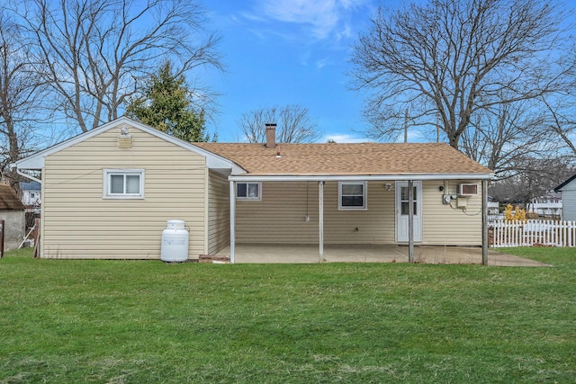 back of property featuring a lawn and a patio