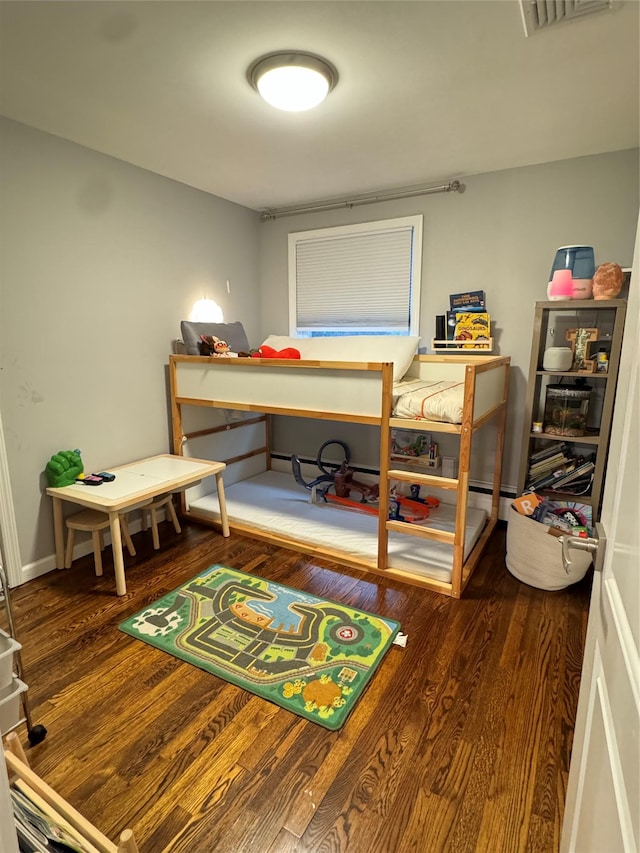 bedroom with dark hardwood / wood-style floors