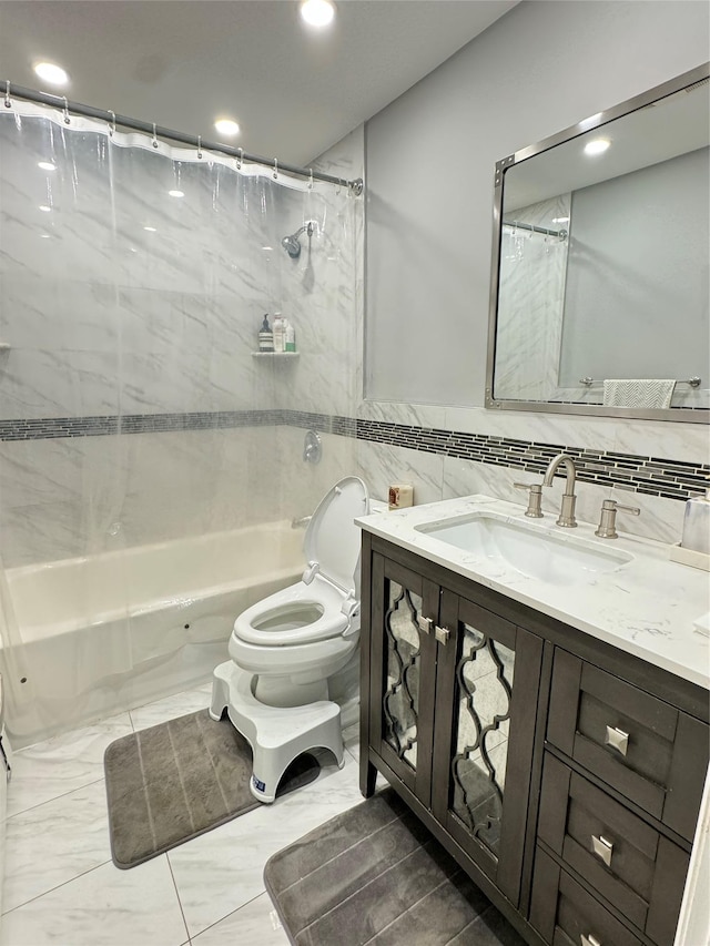 full bathroom featuring vanity, tile walls, shower / bath combination with curtain, and toilet