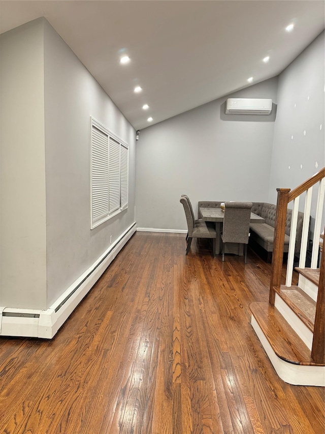 unfurnished dining area featuring a baseboard radiator, an AC wall unit, and wood-type flooring