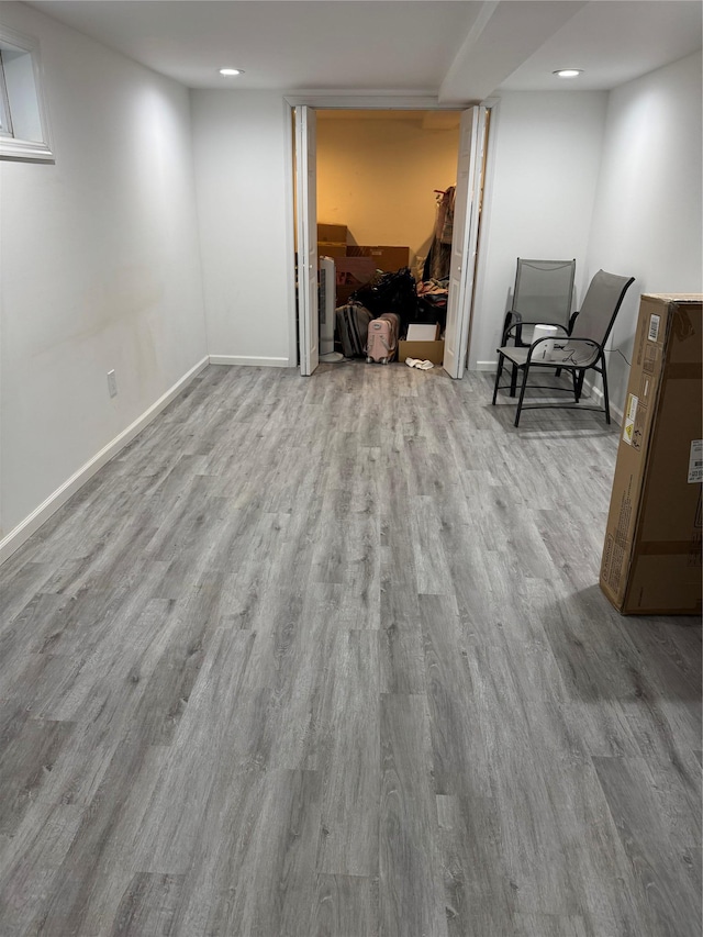 basement with light hardwood / wood-style floors