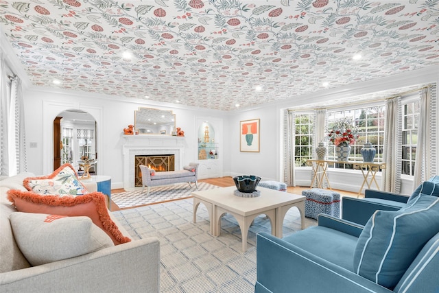 living room featuring light hardwood / wood-style flooring and ornamental molding