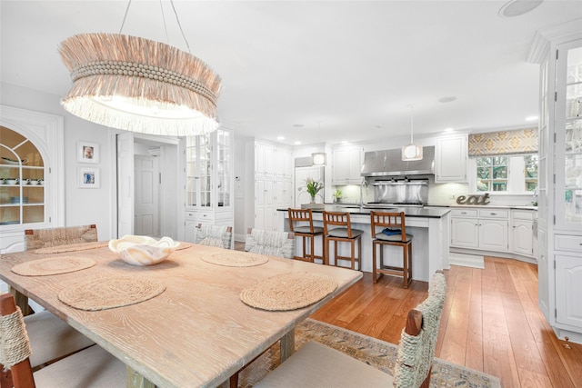 dining space featuring sink and light hardwood / wood-style flooring