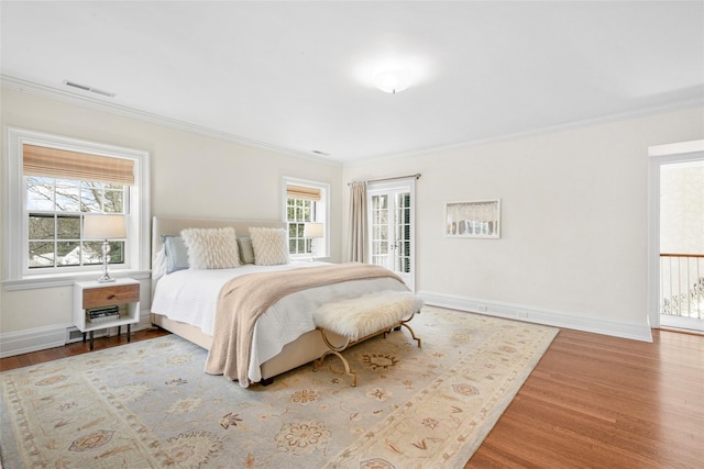 bedroom featuring wood-type flooring and ornamental molding