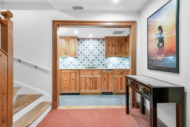 bar with decorative backsplash and light tile patterned floors