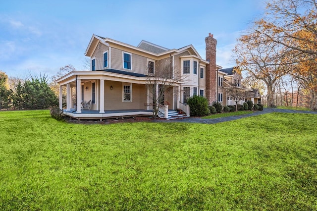 view of front of home with a front yard and covered porch