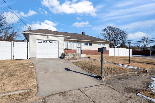 ranch-style home with a garage and a front lawn