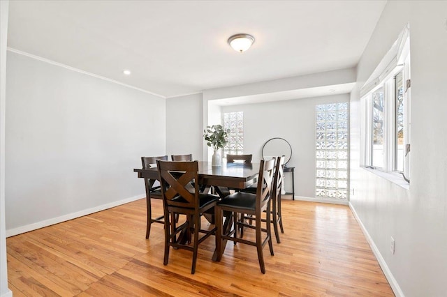 dining room with a wealth of natural light and light wood-type flooring