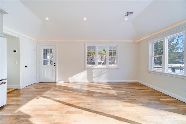 foyer featuring lofted ceiling and light hardwood / wood-style floors