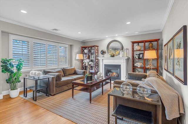 living room with crown molding and light hardwood / wood-style floors