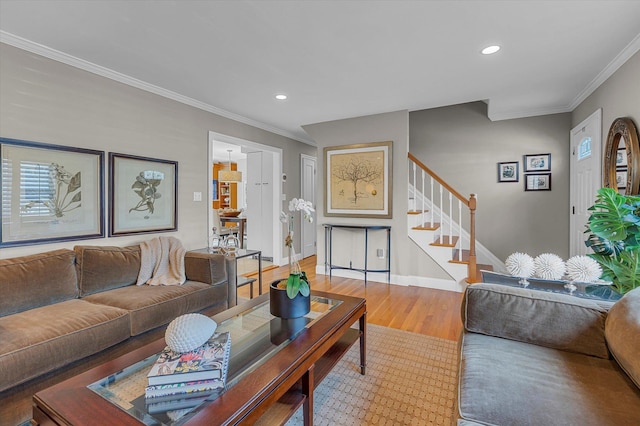 living room featuring crown molding, wood-type flooring, and plenty of natural light