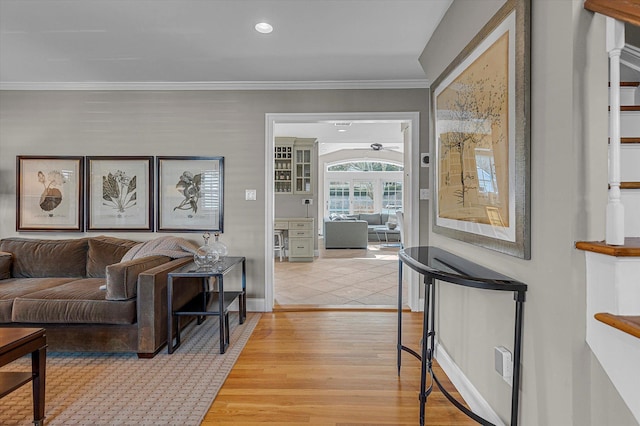 living room featuring wood-type flooring and crown molding