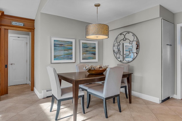 tiled dining room with a baseboard radiator