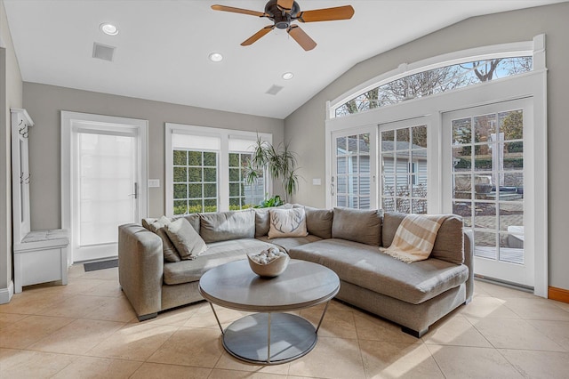 tiled living room with vaulted ceiling, a wealth of natural light, and ceiling fan