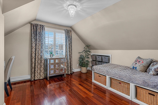 bedroom with lofted ceiling and dark hardwood / wood-style floors