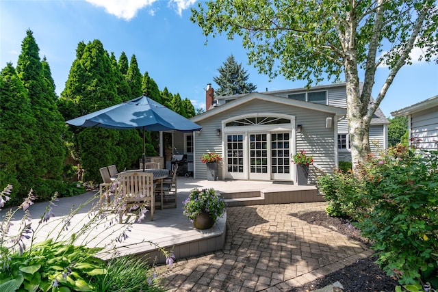 back of property featuring a wooden deck