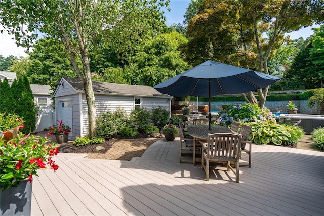 wooden deck with a garage and an outdoor structure