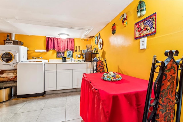 kitchen with white cabinetry, washer / clothes dryer, and light tile patterned floors